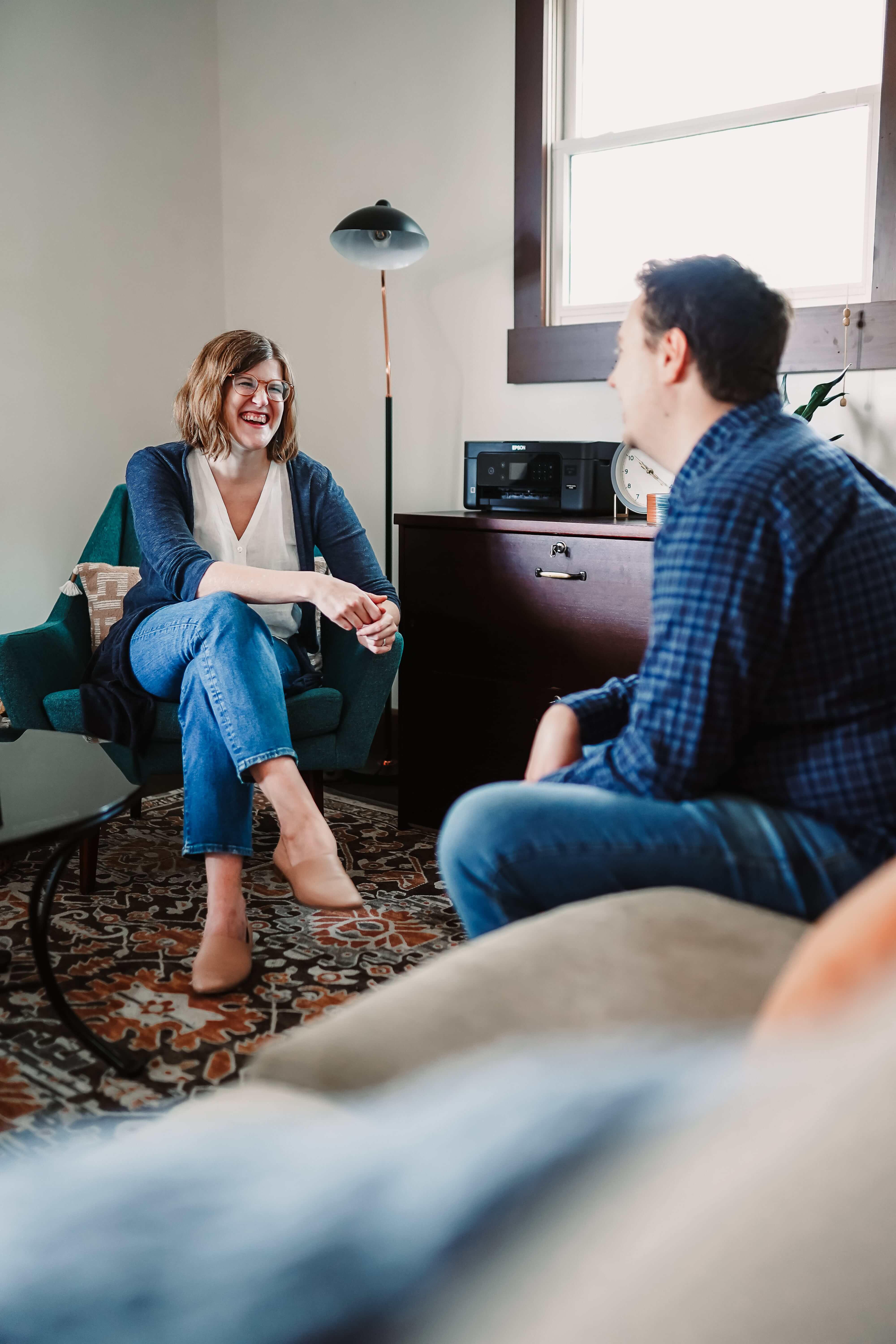 Dr. Ruth Viehoff, anxiety therapy and psychologist, is smiling and happy during an in-person therapy session with a young adult man in Indianapolis, IN