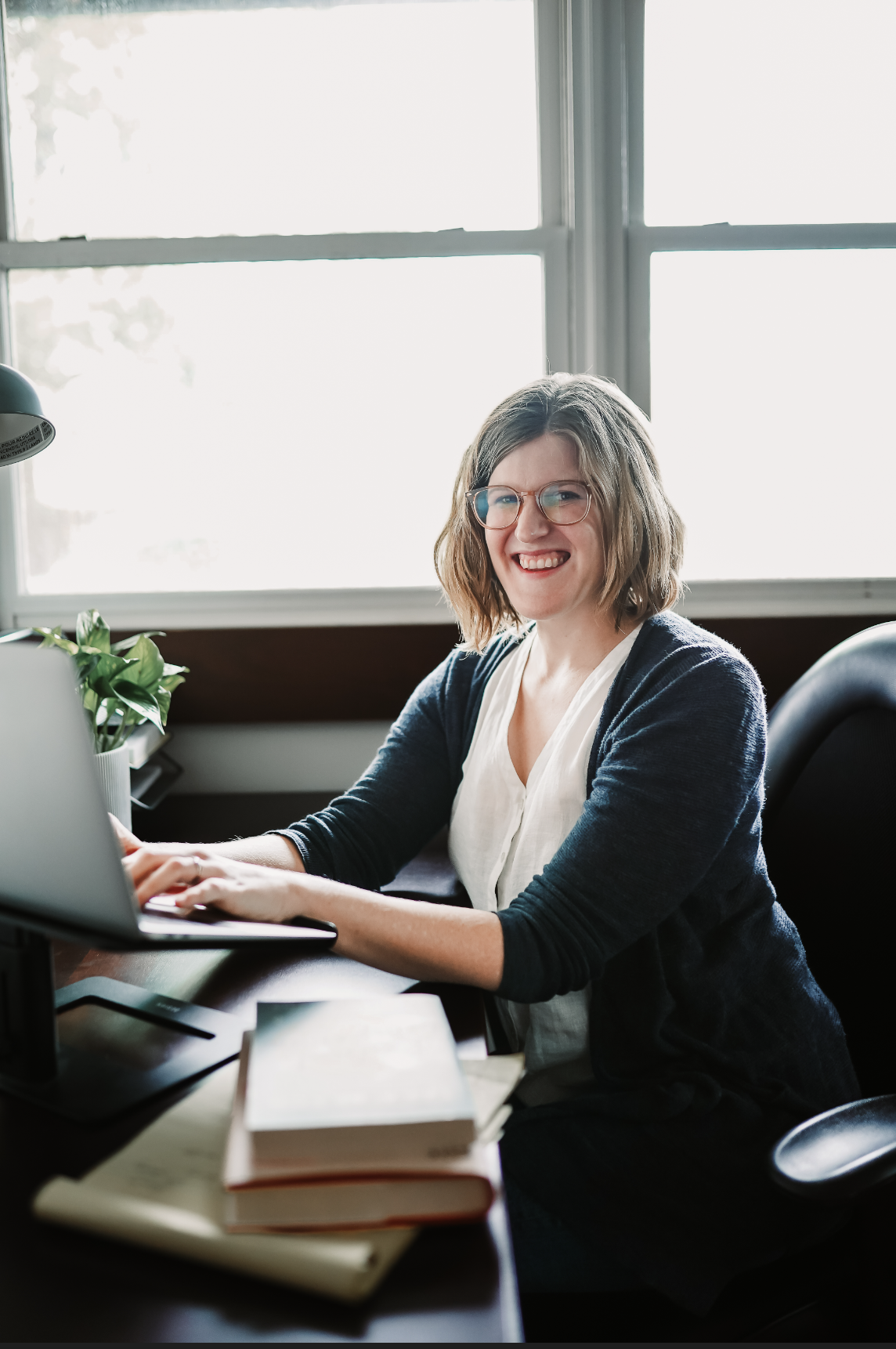 Clinical psychologist and anxiety specialist Dr. Ruth Viehoff is smiling during a telehealth therapy appointment in her Indianapolis office.
